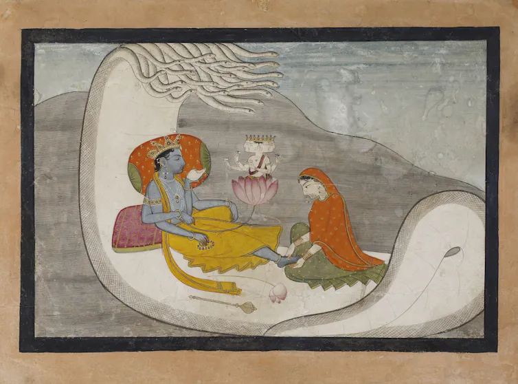 A painting showing a god, with a blue body, reclining on a large white serpent that is floating on water. A woman with her head bowed massages his feet.