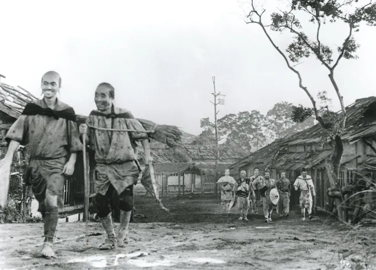 Two samurai walk and laugh together.