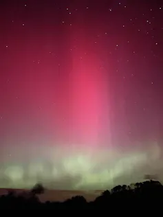 A colourful aurora in a dark night sky.
