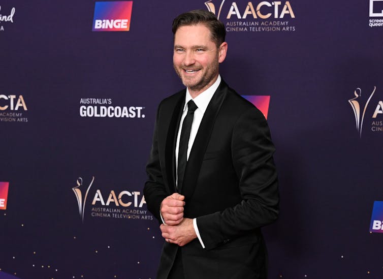 A man in a suit on the red carpet.
