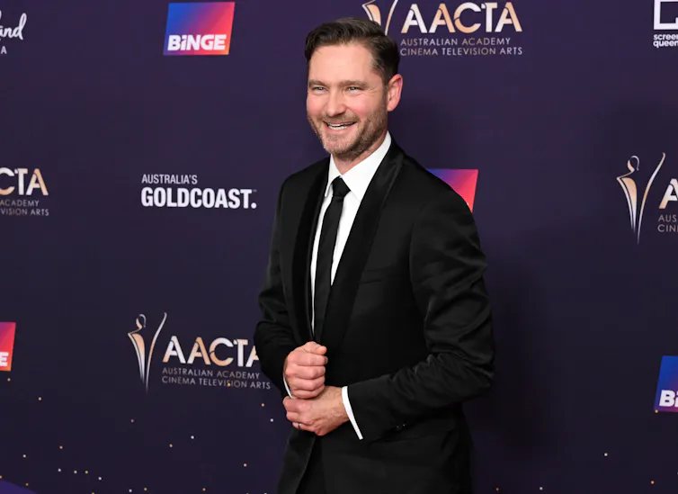 A man in a suit on the red carpet.