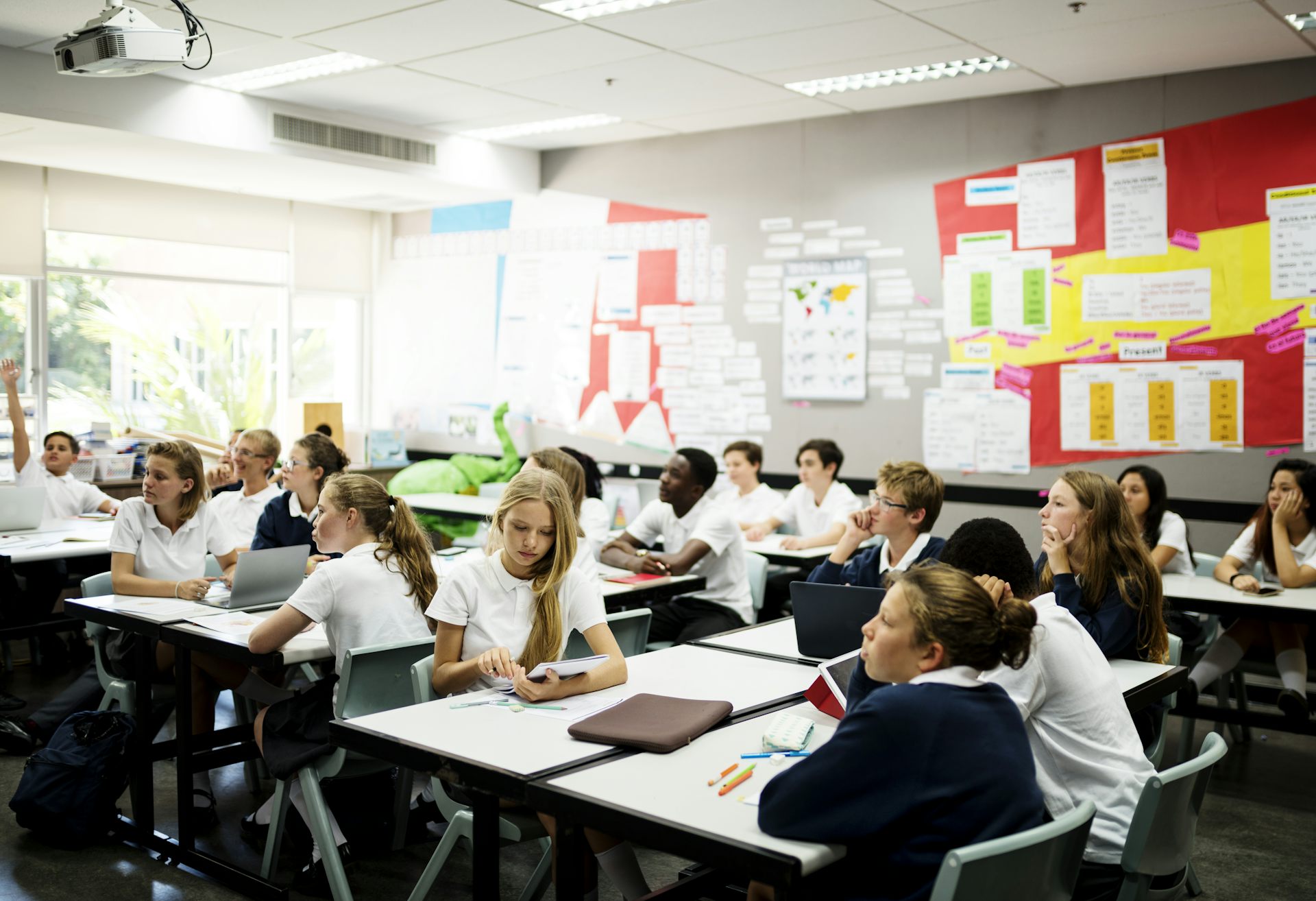 Students sit at desks in a classroom.