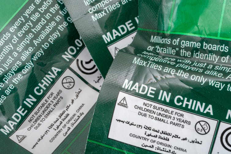 Bags of Scrabble-like letter tiles with 'Made in China' printed on the packet.