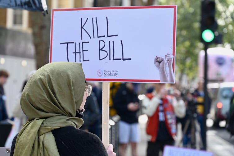 A person holding a placard saying 'kill the bill'.