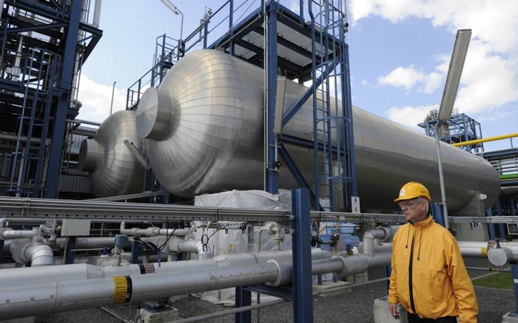 Worker with hardhat in industrial setting.