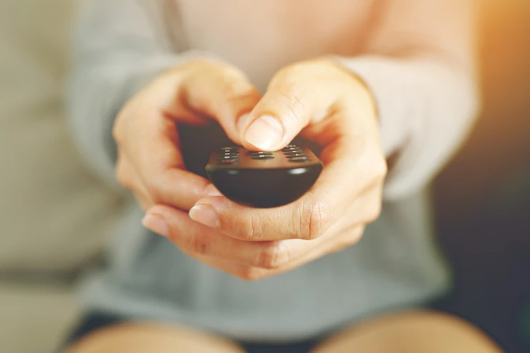 closeup of hands holding remote