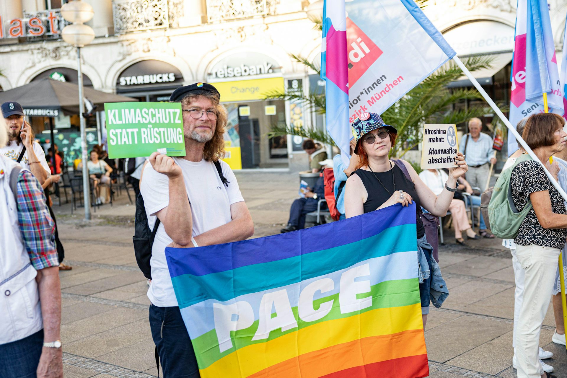 An anti-war protester carries a flag saying Pace (peace)