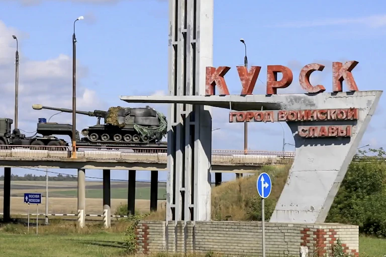 Russian armour on its way to the frontline in Kursk province, with a Russian language sign saying Kursk.