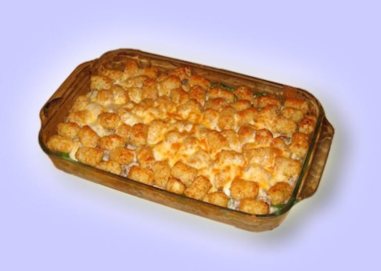 A rectangular casserole dish with golden brown potatoes in it.