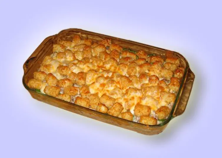 A rectangular casserole dish with golden brown potatoes in it.