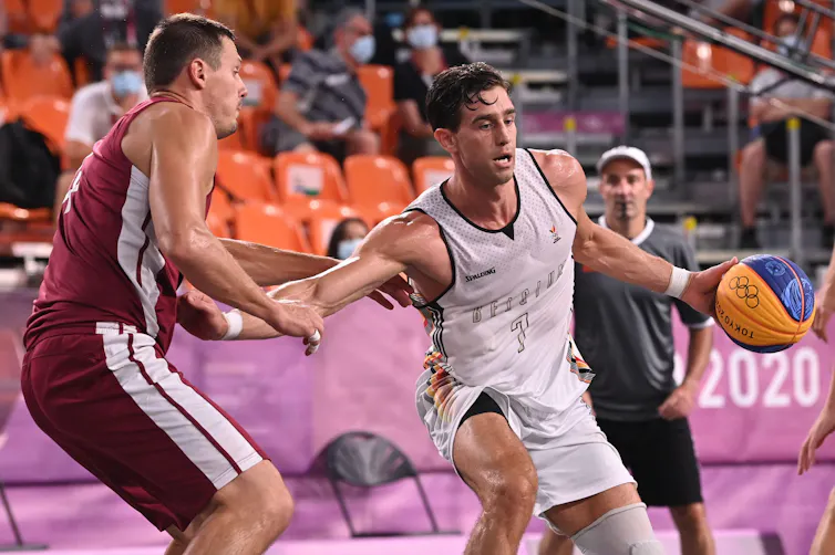 Two young athletes playing 3x3 basketball at the Tokyo Olympics.
