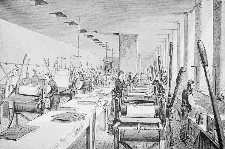 a black and white drawing of a high-ceilinged room containing two rows of printing machines and people tending them