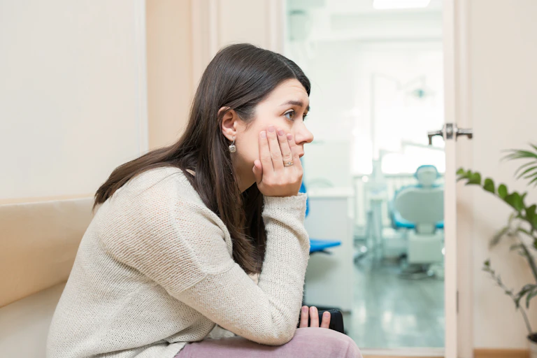 Woman waits for doctor, looking anxious
