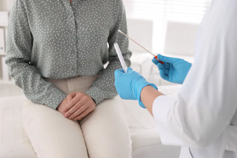 Clinician holds vaginal swab