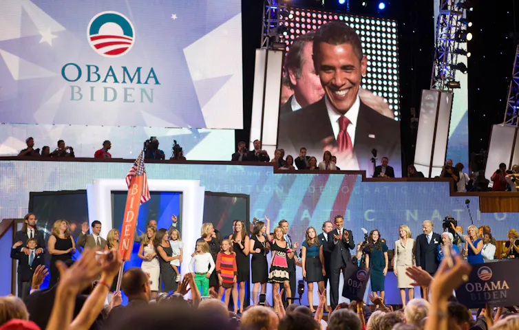 An image of the 2008 Democratic convention with Barack Obama and Jo Biden's families on stage.