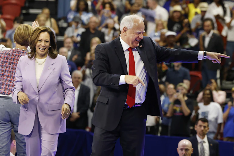 Kamala Harris and Tim Walz on stage at a campaign rally in Las Vegas, August 10.