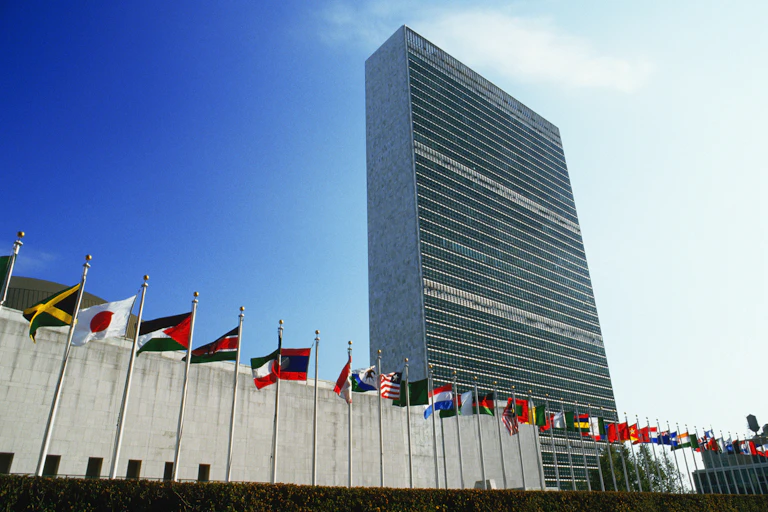 Image of a skycraper with flags of several countries.