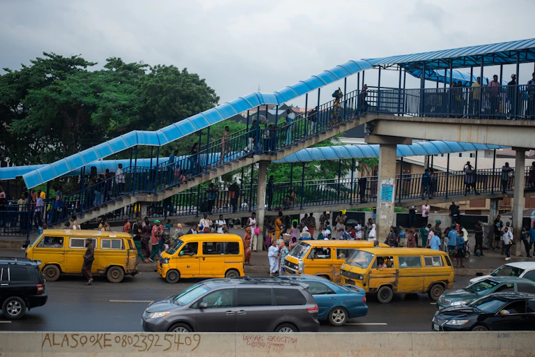Commuters and vehicles at a bus stop