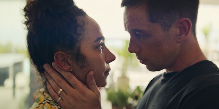Aurora Perrineau as Riddy, Killian Scott as Orpheus looking at each other.