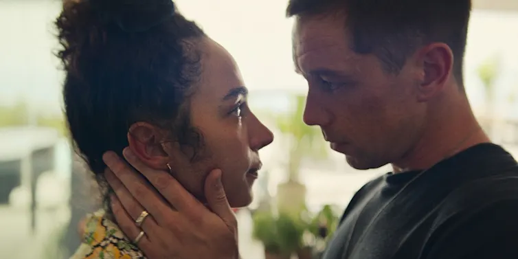 Aurora Perrineau as Riddy, Killian Scott as Orpheus looking at each other.