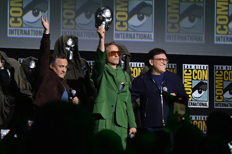 Robert Downey Jr holding up the Doctor Doom mask
