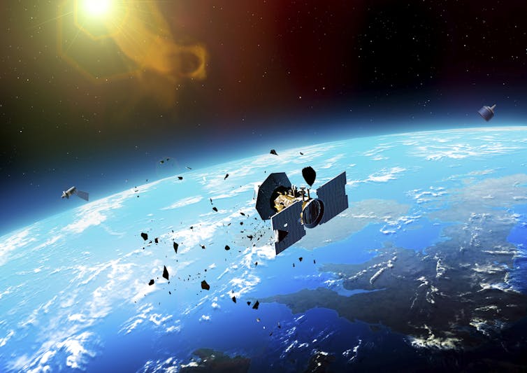 An illustration showing pieces of metal flying around a satellite in orbit around the Earth.