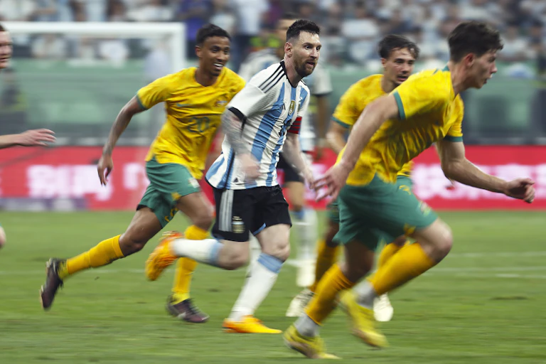 Lionel Messi weaves through some defenders for Argentina