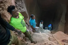 Four miners in a self dug pit about 30 feet deep