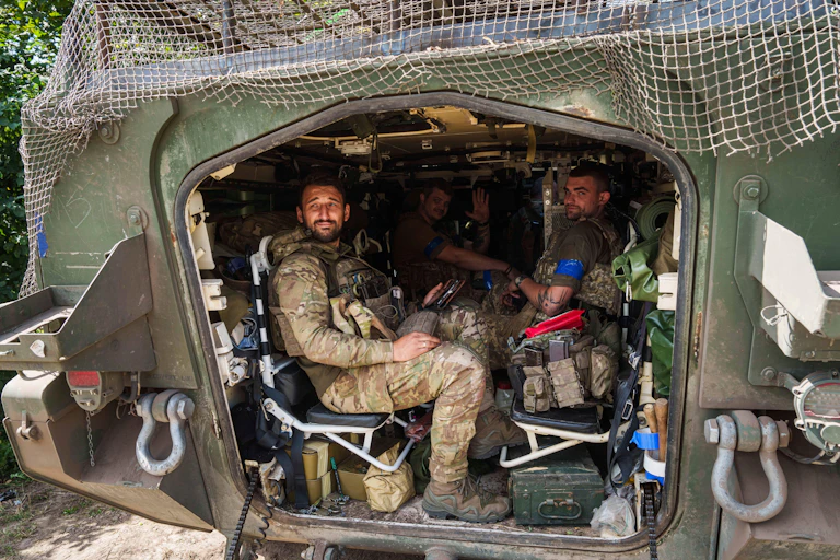 Ukrainian troops relax in an armoured personnel carrier.