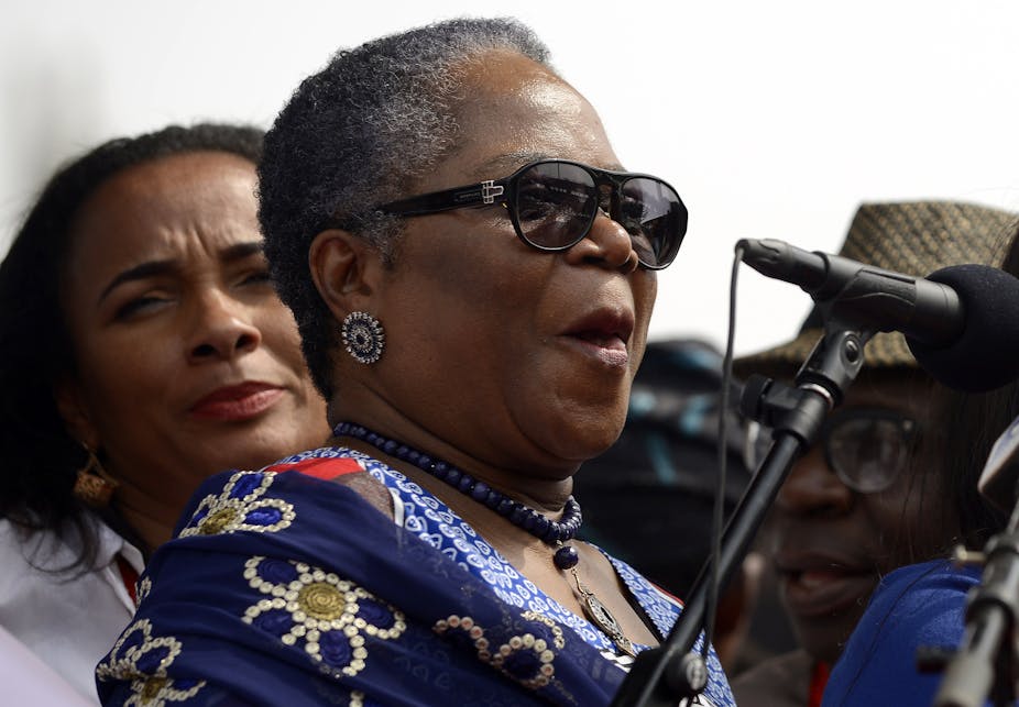 A woman standing behind a microphone