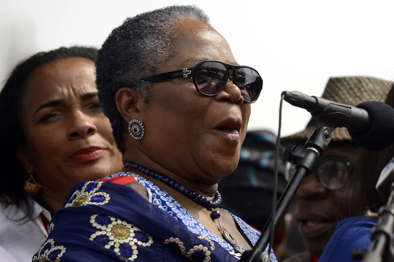 A woman standing behind a microphone