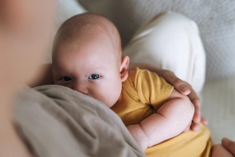 A young baby being breastfed