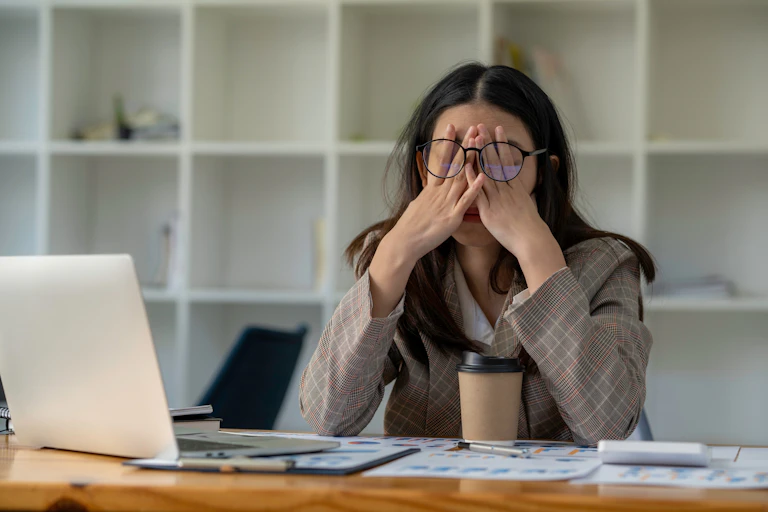 stressed woman sitting with a laptop