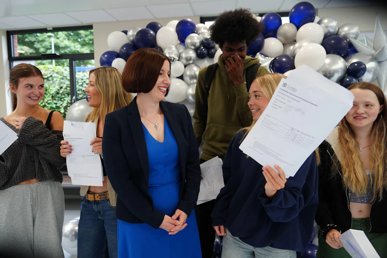 Bridget Phillipson talking to a girl holding up her A-level results.