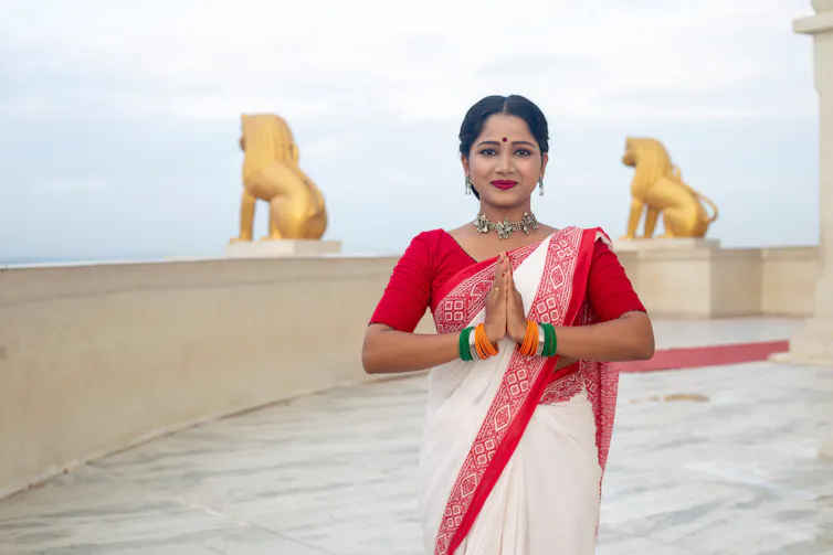 A woman demonstrating the Namaste greeting.