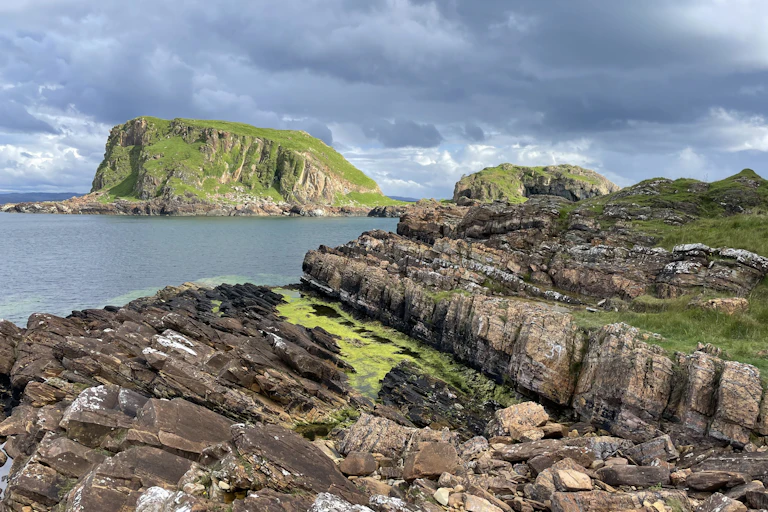 Standing on limestone beds of the pre-glacial Garvellach Formation, looking North from Garbh Eileach over to Dun Chonnuil.