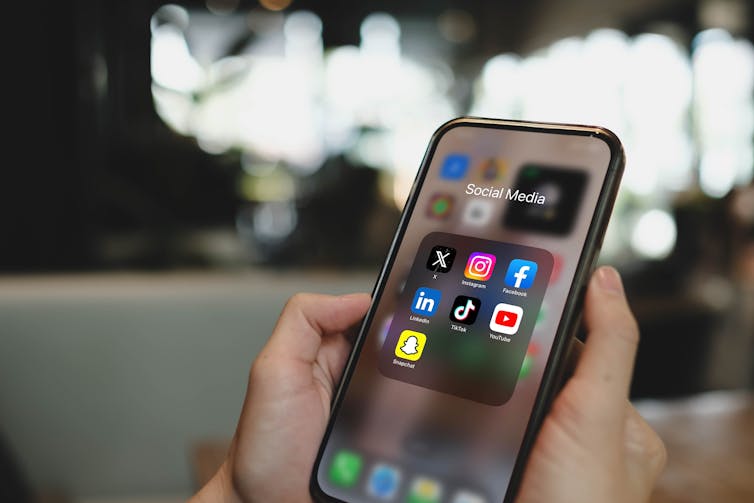 Mobile phone screen with social media application icons.