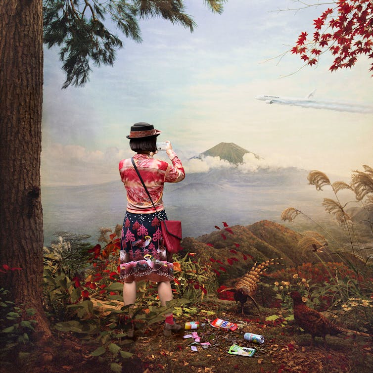 A woman looks over a vista.