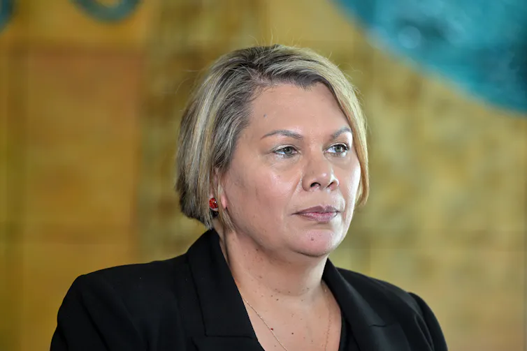 The head and shoulders of a woman in a black blazer