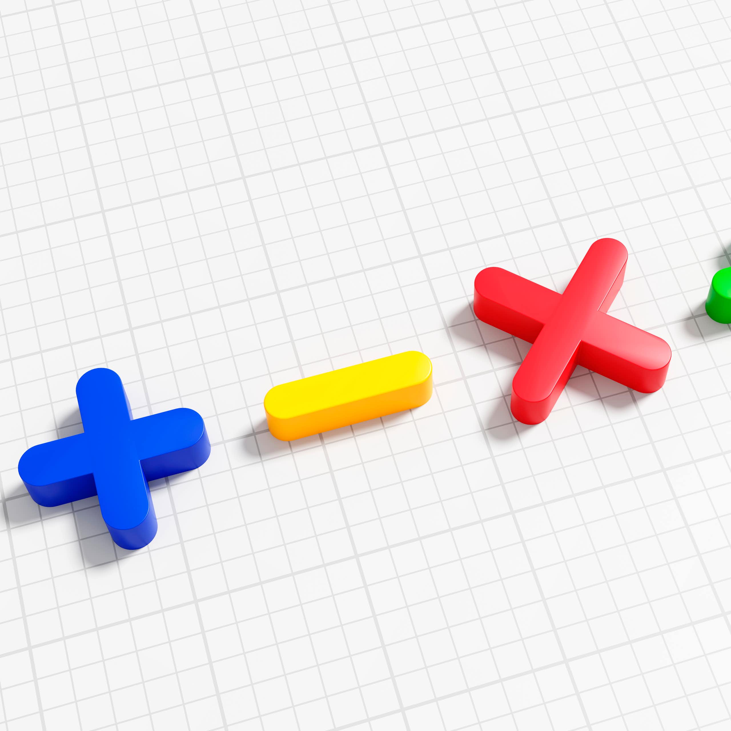 Symbols for addition, subtraction multiplication and division on graph paper