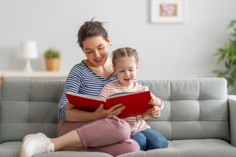 A child with a book looks uncertain.