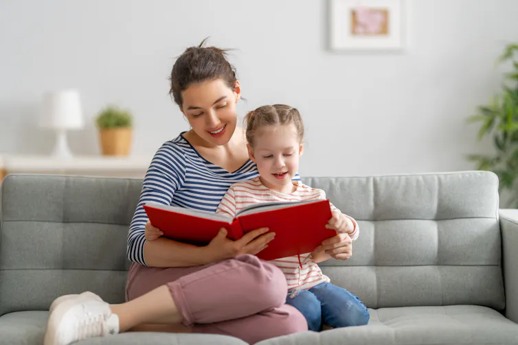 A child with a book looks uncertain.