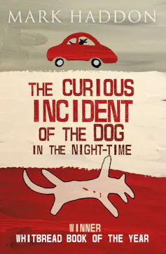 The cover of Curious Incident of the Dog in the Night-time, with a red car on top, above the title, and a dead dog below it