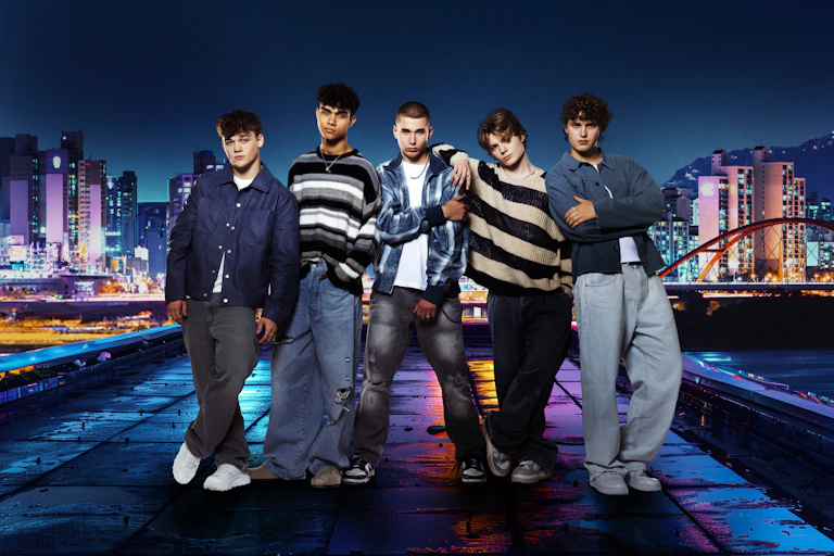 Five boys with South Korean skyline in the background