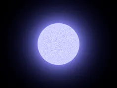A cool toned white glowing ball on a black background.