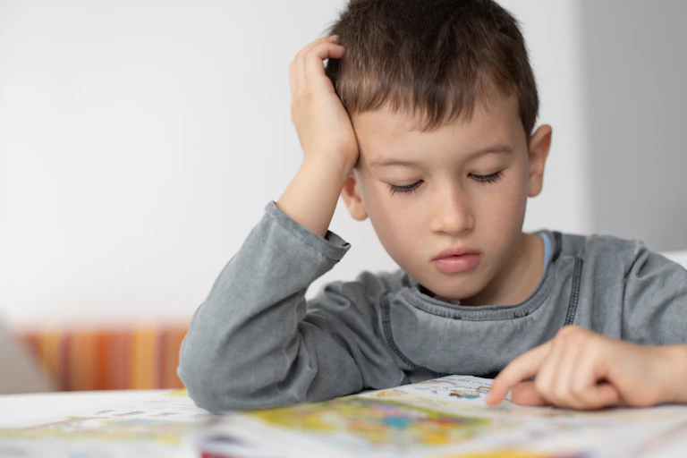 A child concentrating with a book.