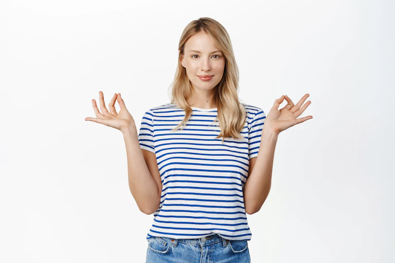 Young woman holds her fingers in a meditation pose.