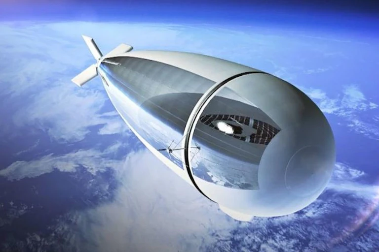 An airship with a blue and white curve of earth below it and a shiny portion of solar panels along one side of the ship