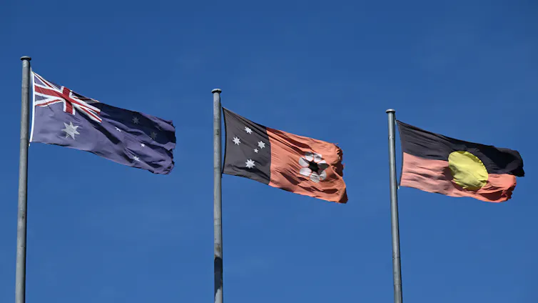 The Australian, Northern Territory and Aboriginal flags fly