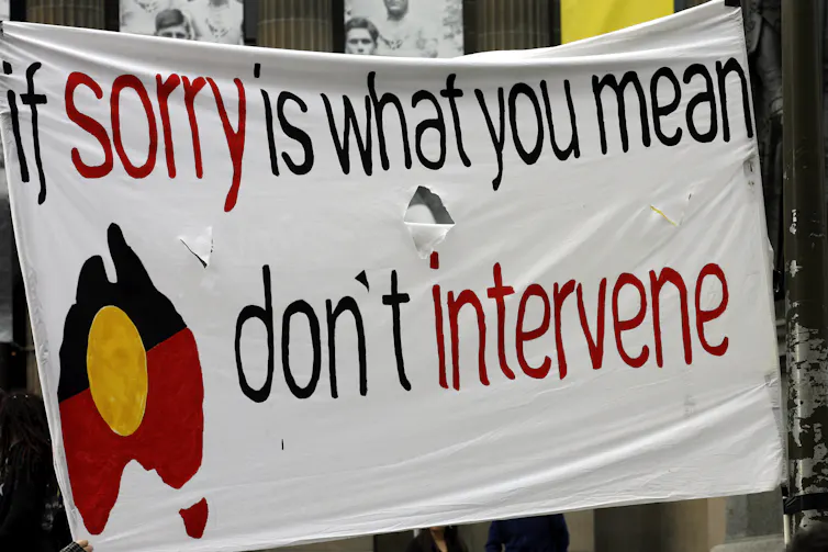 A protest sign that says if sorry it what you mean, don't intervene.